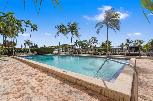 a view of swimming pool with a table and chairs