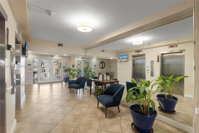 a lobby with furniture and a potted plant