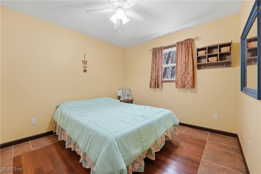 4254 Doral Road Southwest Carrollton, OH 44615 - Photo 27 of 46 Bedroom with wood finished floors and ceiling fan