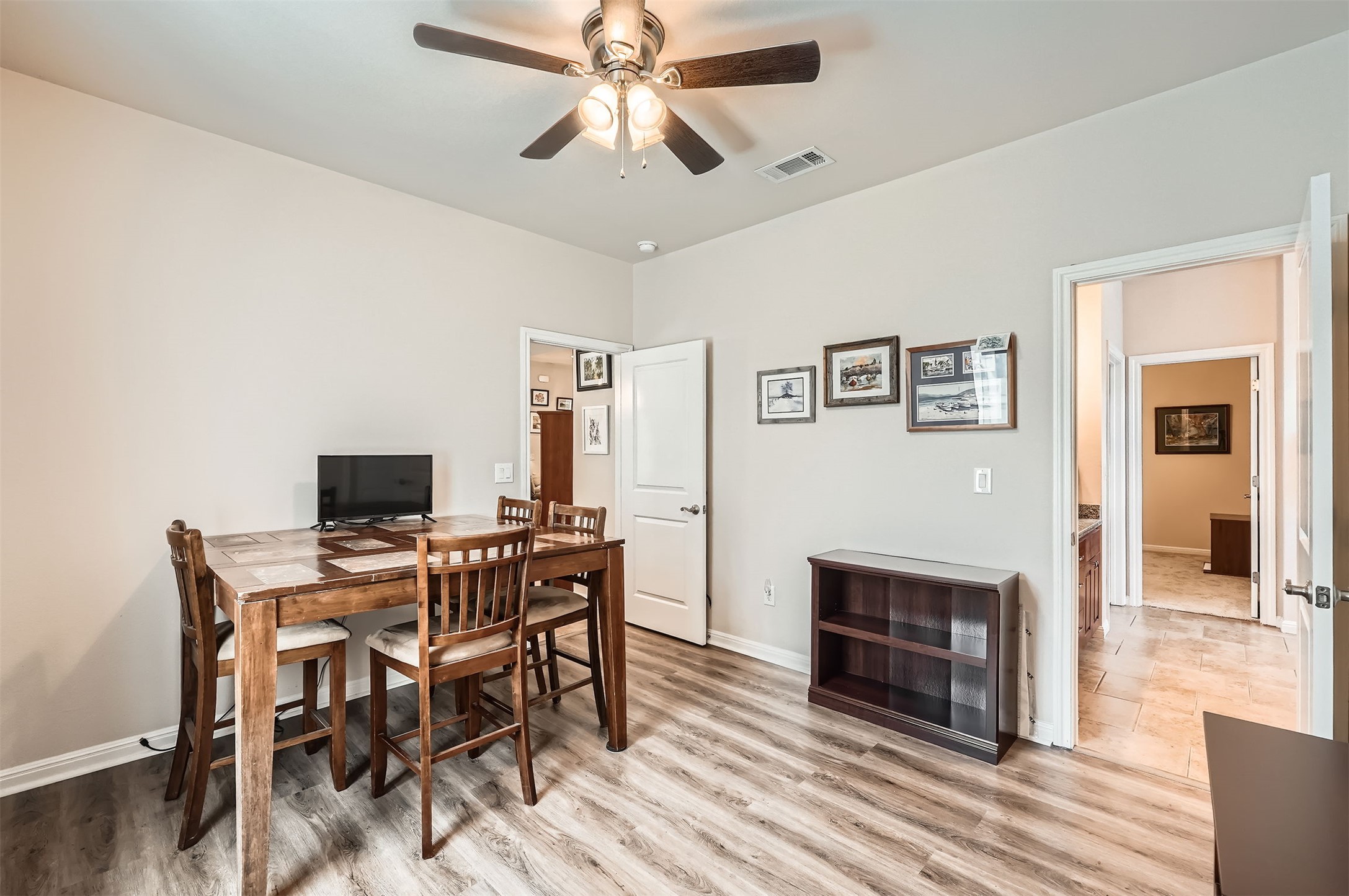 5501 Hitching Post Lago Vista, TX 78645 - Photo 20 of 26 a view of a dining room with furniture window and wooden floor