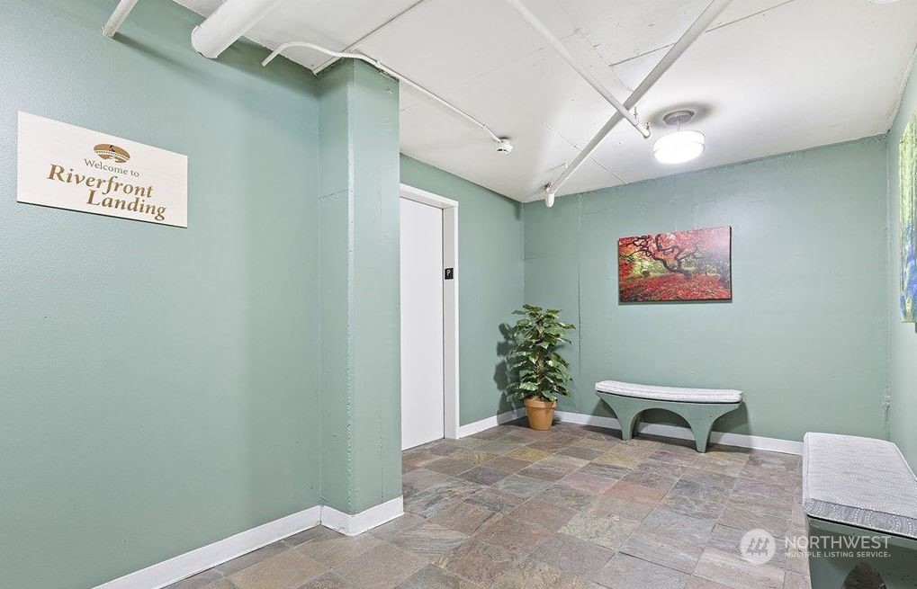 17426 Bothell Way Northeast, Unit A108 Bothell, WA 98011 - Photo 19 of 24 a view of a hallway with paintings on the wall