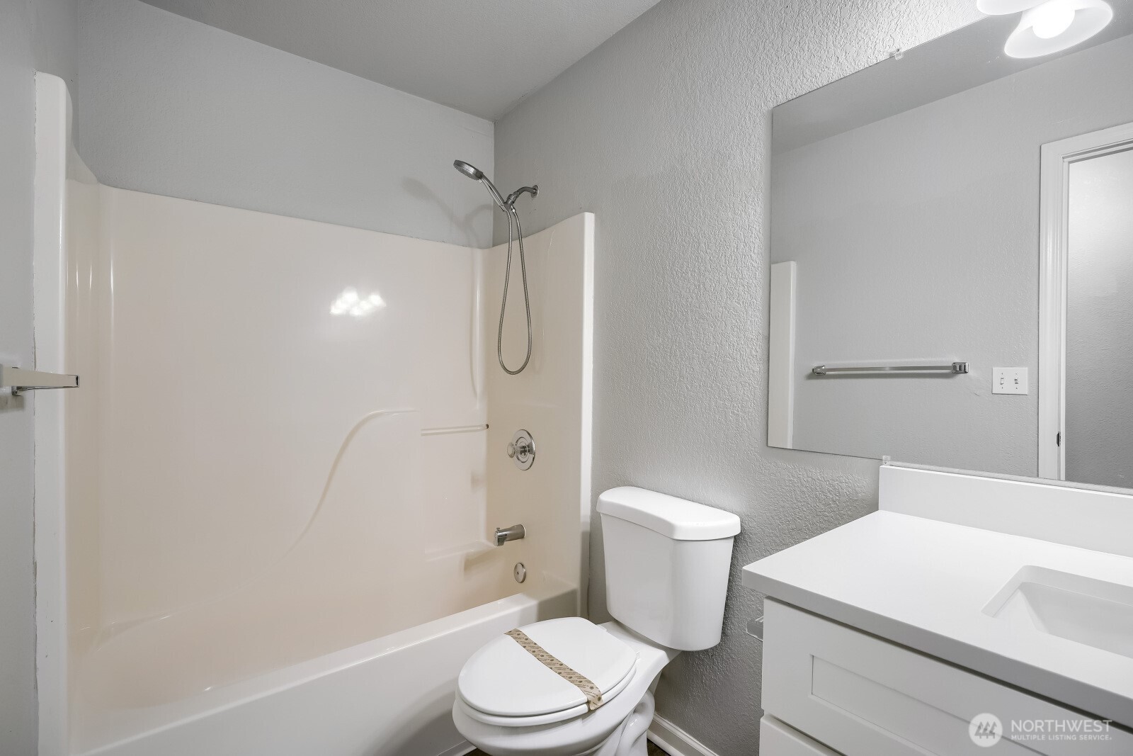 1607 Springfield Court Northeast Olympia, WA 98506 - Photo 17 of 21 a white toilet sitting next to a bath tub