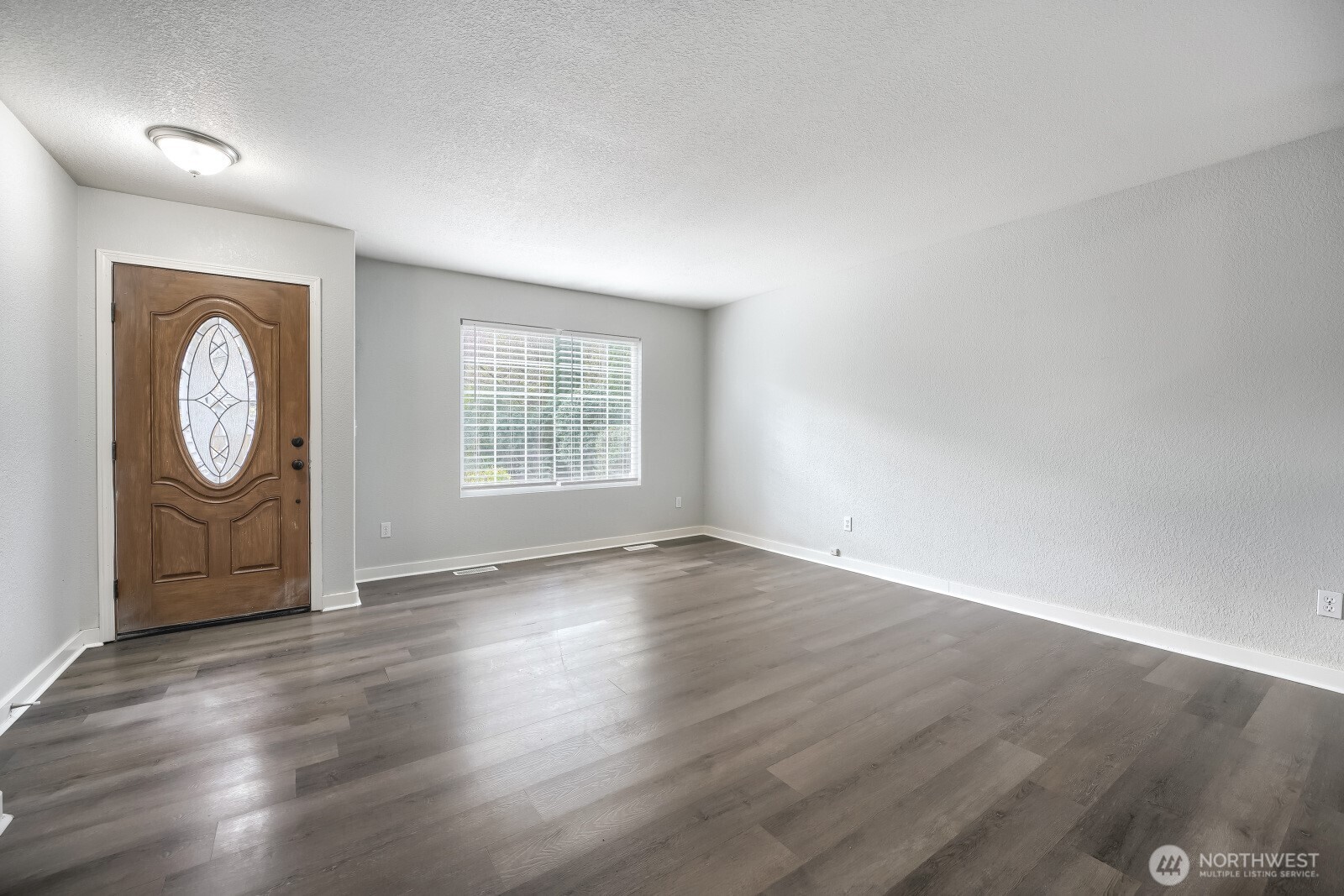 1607 Springfield Court Northeast Olympia, WA 98506 - Photo 3 of 21 an empty room with wooden floor and windows