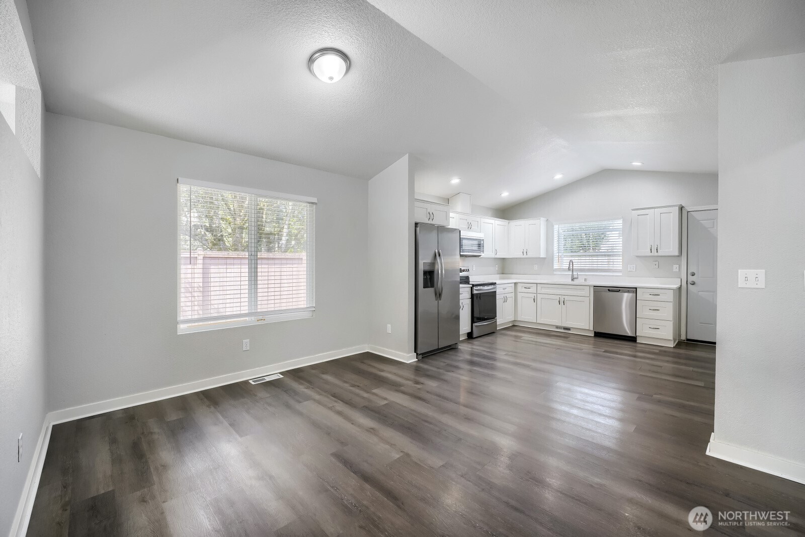 1607 Springfield Court Northeast Olympia, WA 98506 - Photo 5 of 21 a view of a kitchen with stainless steel appliances wooden floor and a window