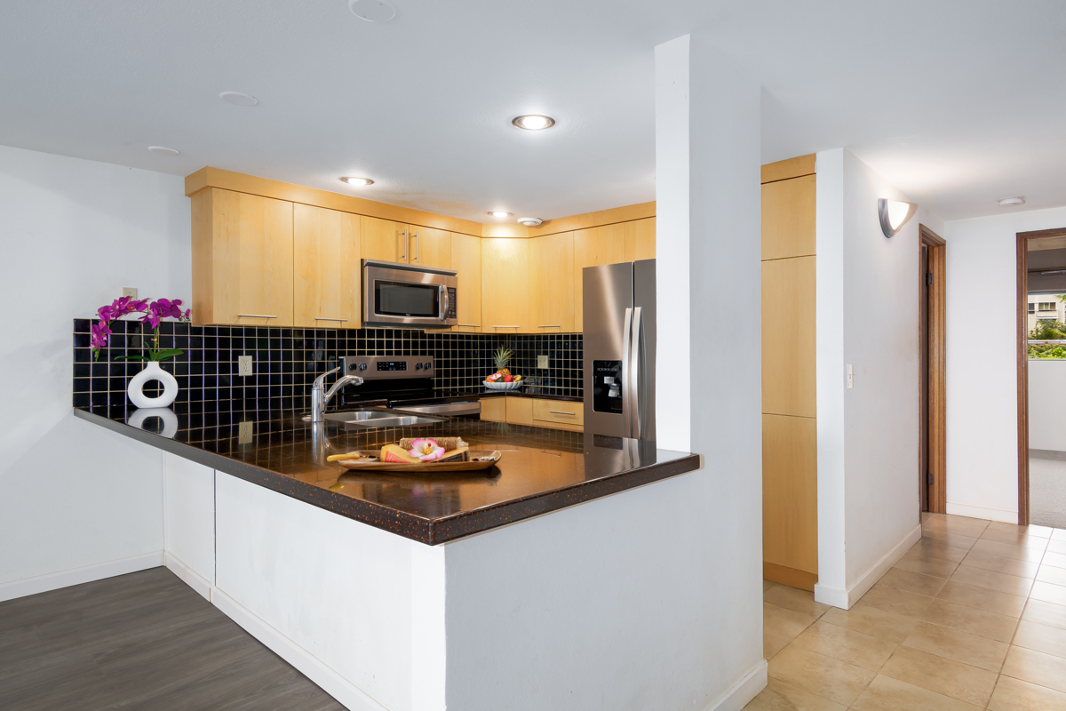 68-3840 Lua Kula Street, Unit D201 Waikoloa, HI 96738 - Photo 6 of 30 a kitchen with stainless steel appliances granite countertop a refrigerator and a stove