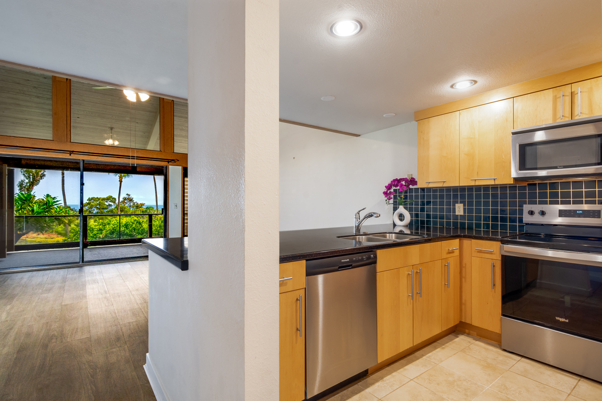 68-3840 Lua Kula Street, Unit D201 Waikoloa, HI 96738 - Photo 7 of 30 a kitchen with stainless steel appliances granite countertop a sink and a microwave