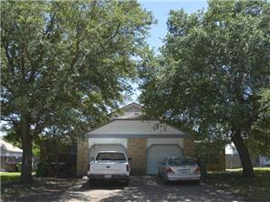 a car parked in front of a white house