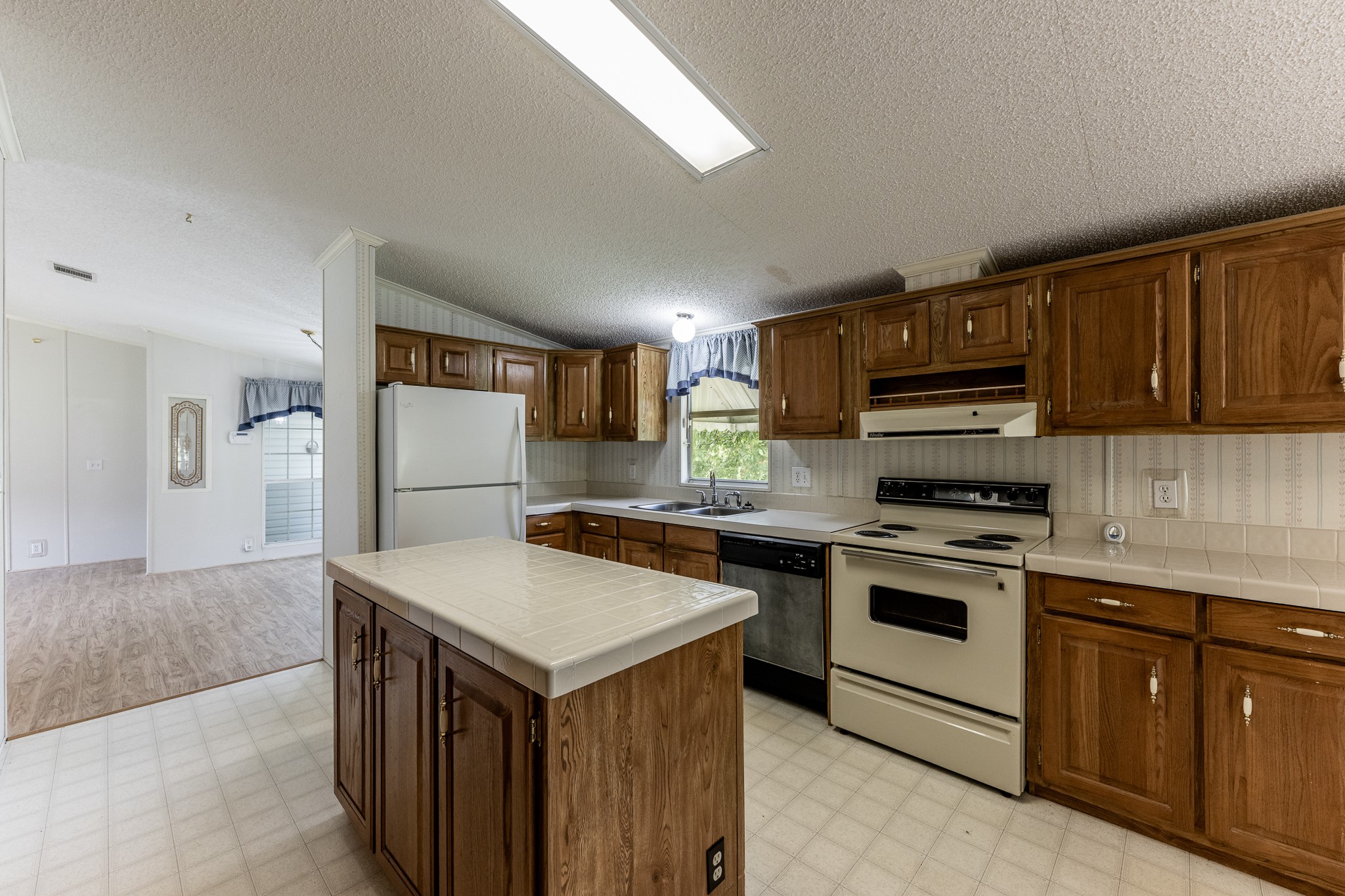 227 Cutter Drive Trinity, TX 75862 - Photo 12 of 39 a kitchen with a stove a sink and a refrigerator