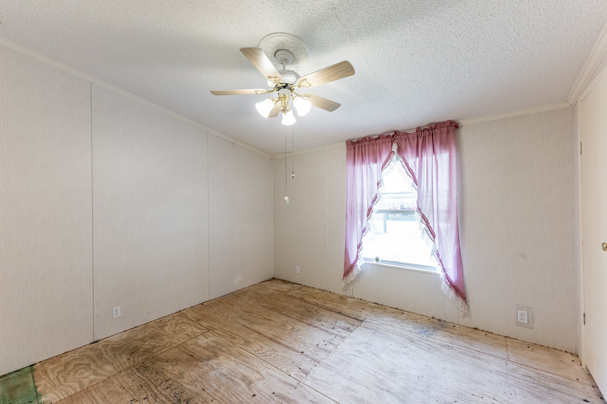 227 Cutter Drive Trinity, TX 75862 - Photo 23 of 39 an empty room with windows and fan