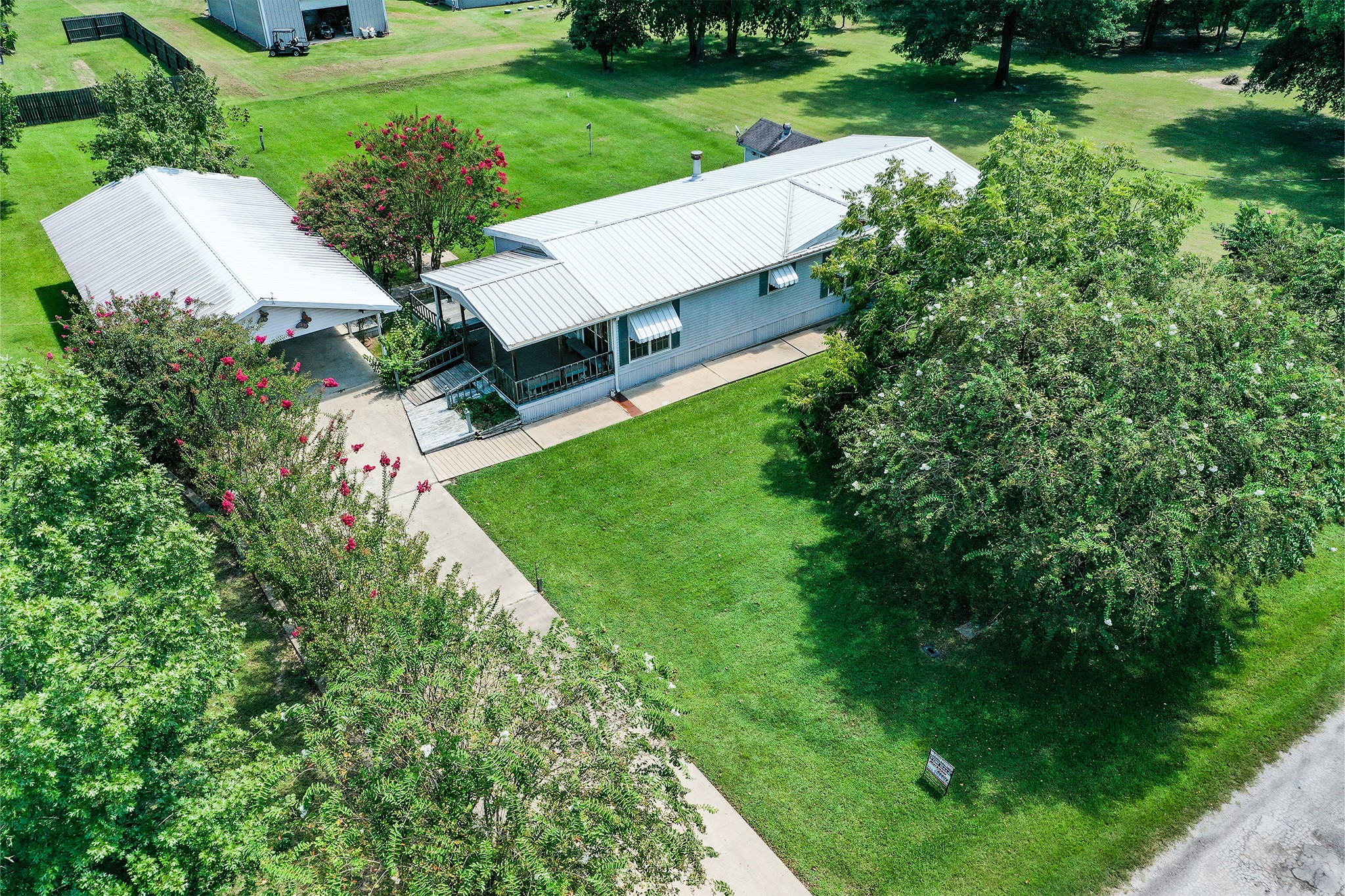 227 Cutter Drive Trinity, TX 75862 - Photo 3 of 39 a view of a garden with plants and large trees