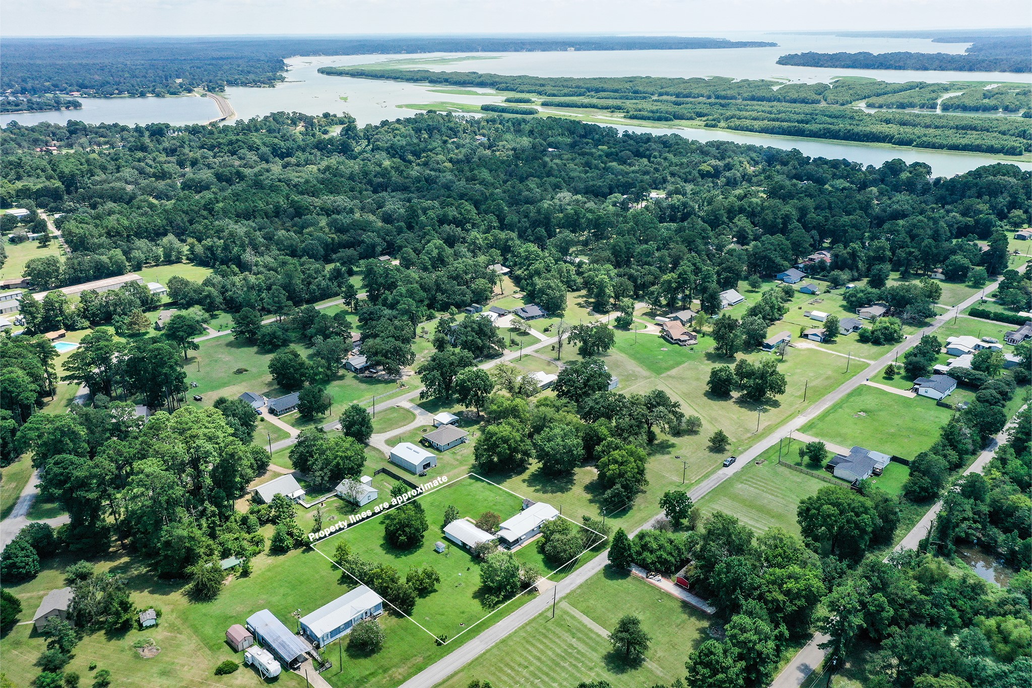 227 Cutter Drive Trinity, TX 75862 - Photo 33 of 39 an aerial view of a houses with outdoor space and trees all around