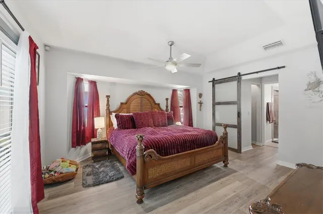 a bedroom with a bed and a chandelier