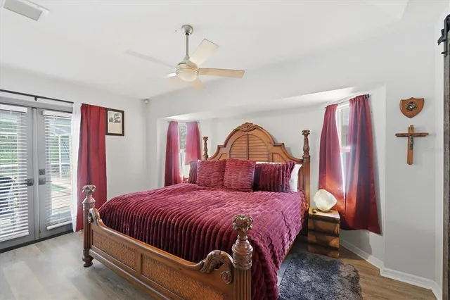 a bedroom with a bed and a chandelier