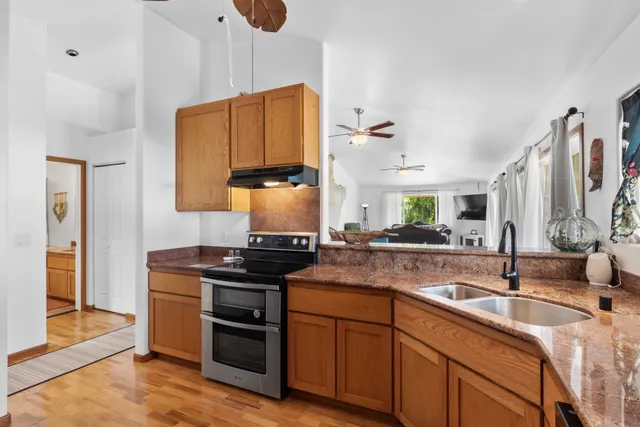 a kitchen with stainless steel appliances a sink stove and cabinets