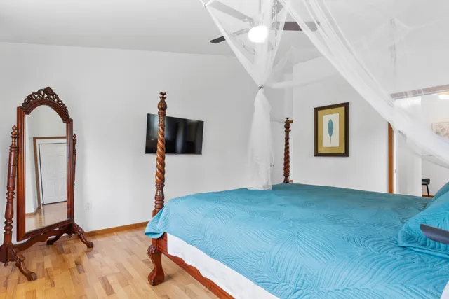 a bedroom with a bed and a flat screen tv