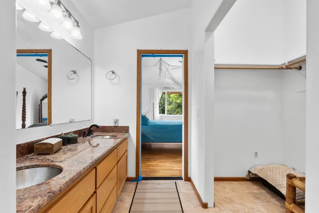 a bathroom with a sink a granite floor and a shower