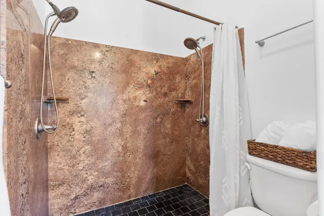 a bathroom with a shower and a toilet