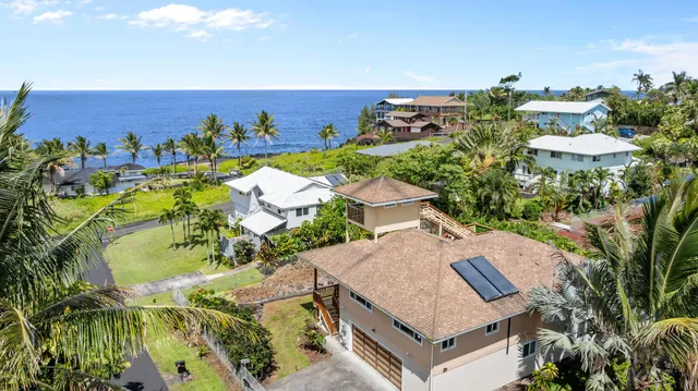 an aerial view of a house with a swimming pool and garden view