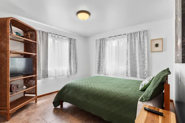 a bedroom with a bed closet and flat tv screen