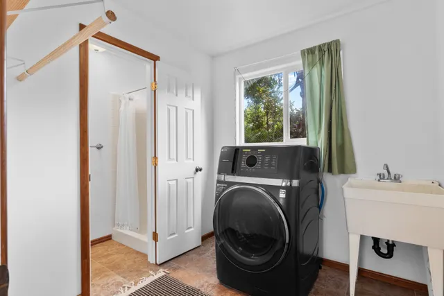 a utility room with sink dryer and washer