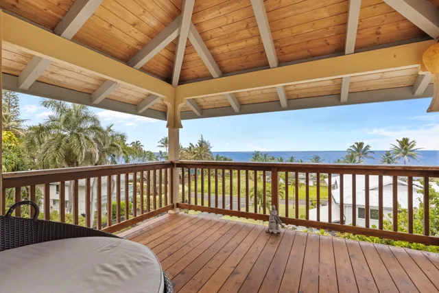a view of balcony with wooden floor
