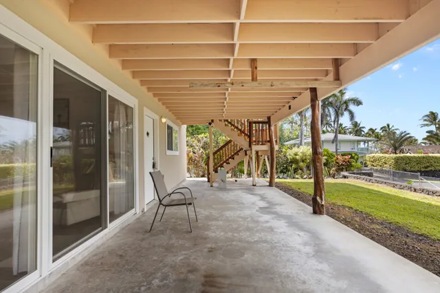 a view of a porch with furniture and floor to ceiling window