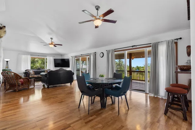 a living room with furniture a table and a large window