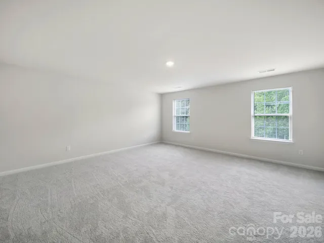 a view of an empty room with a kitchen