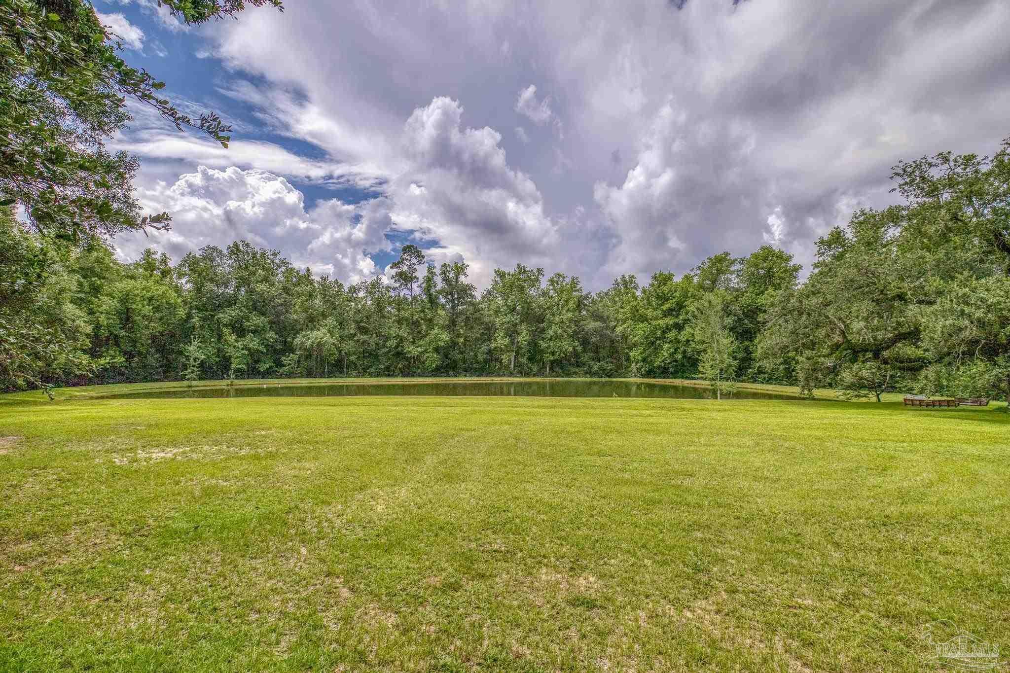 2345 Pompano Street Cantonment, FL 32533 - Photo 10 of 48 a view of an ocean and a yard