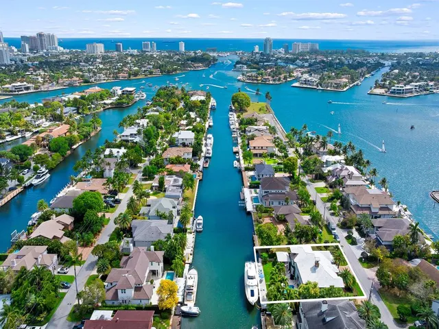an aerial view of residential houses with outdoor space and swimming pool