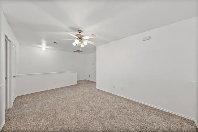a view of a hallway with wooden floor and closet