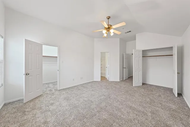 a spacious bathroom with a tub sink and mirror