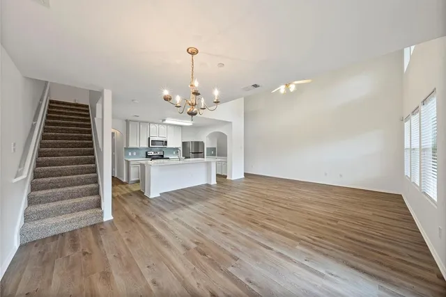 a view of a kitchen with wooden floor and staircase