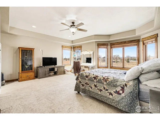 a bed room with a bed a television and dresser