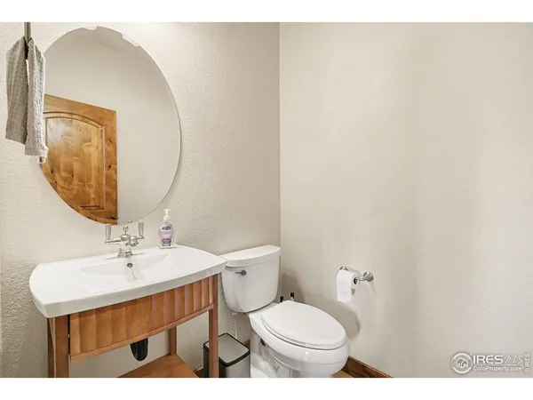 a bathroom with a sink a toilet and mirror