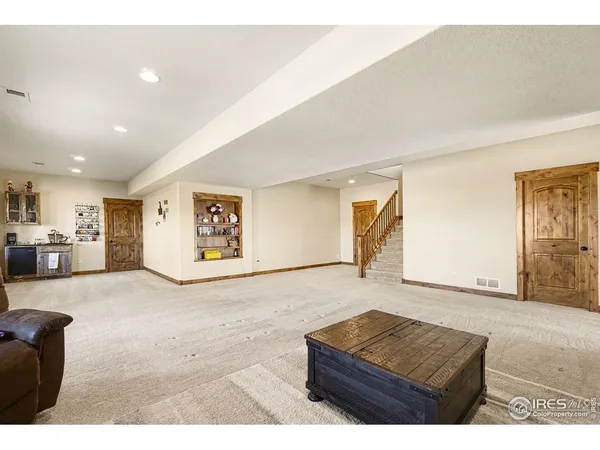 a living room with furniture and mirror