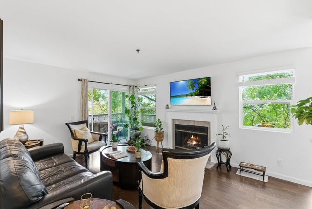 a living room with furniture fireplace and window