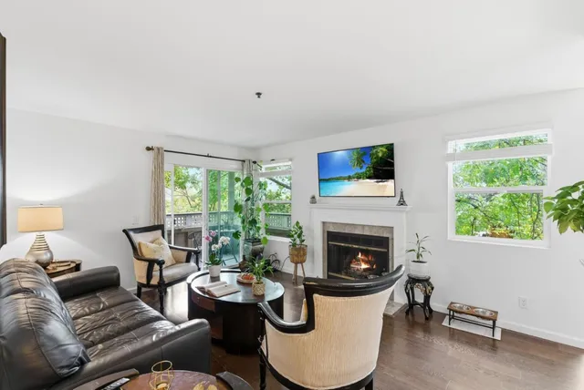 a living room with furniture fireplace and window
