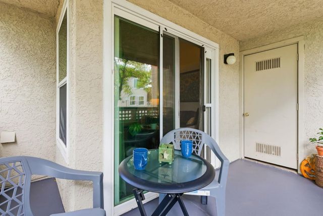 a dining room with furniture and a floor to ceiling window