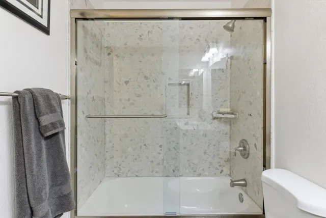 a bathroom with a shower and a bath tub