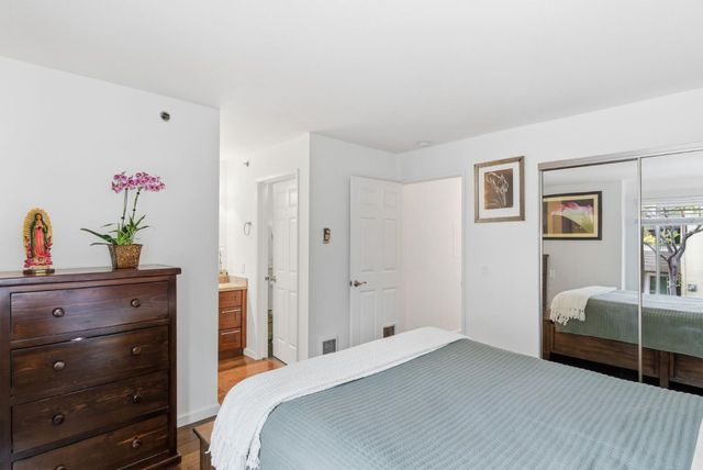 a bedroom with a bed and a dresser