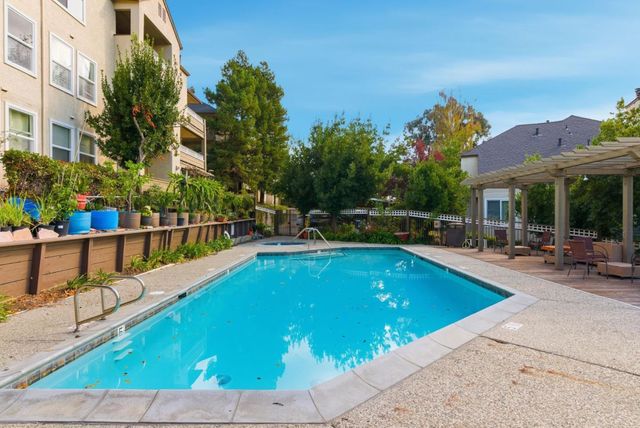 a view of a swimming pool with a lounge chair