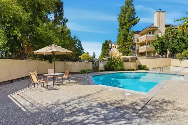 a view of a backyard with sitting area