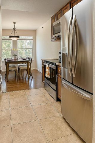a kitchen with stainless steel appliances granite countertop a refrigerator and a stove top oven