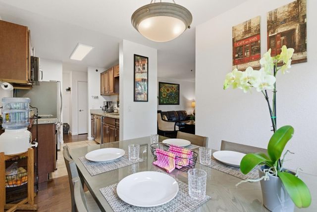 a living room with furniture a rug and a chandelier