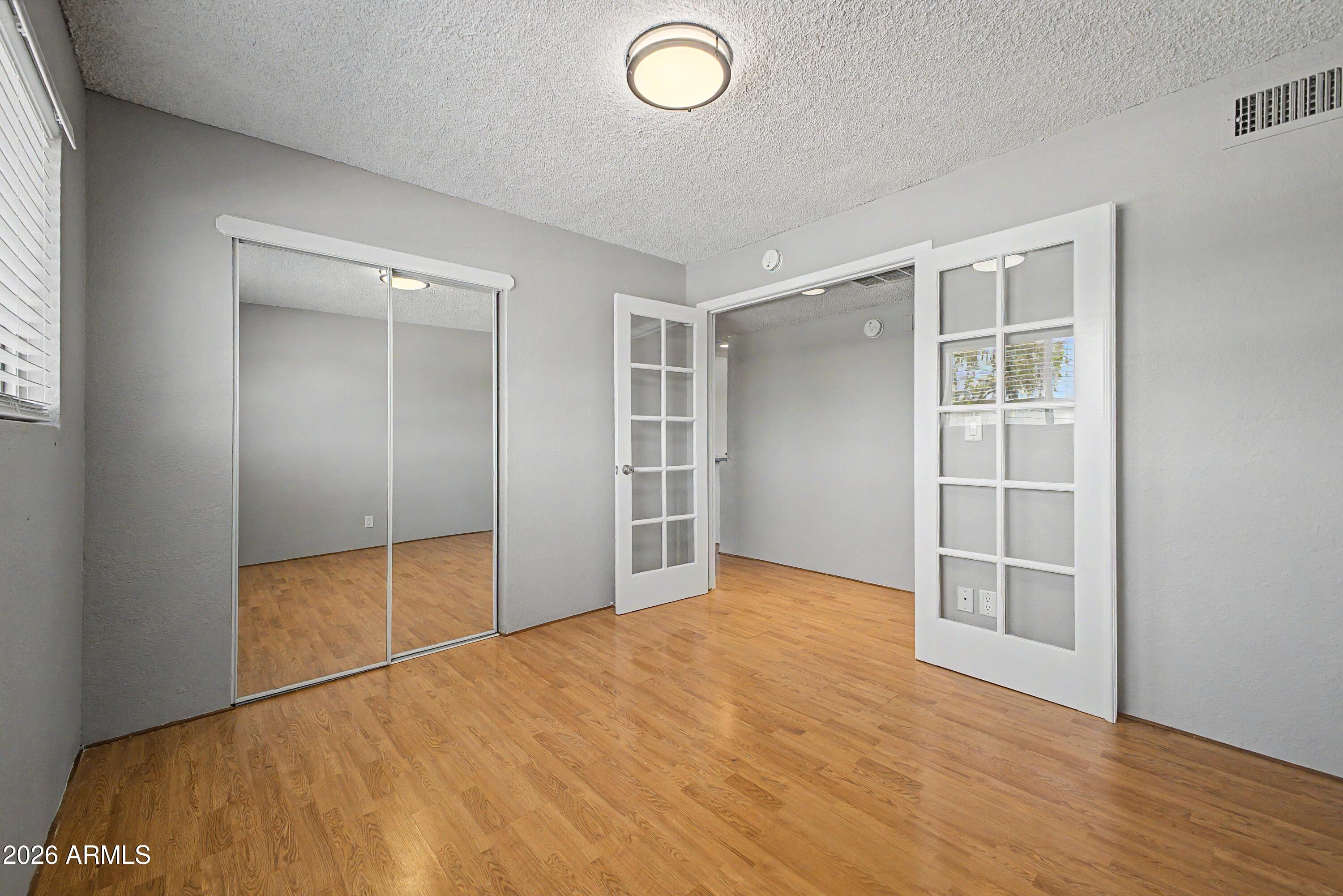 424 West Brown Road, Unit 248 Mesa, AZ 85201 - Photo 12 of 19 an empty room with wooden floor and closet