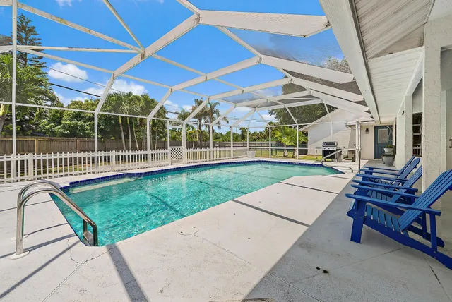 a view of a backyard with sitting area