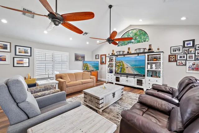 a living room with furniture kitchen view and a fireplace