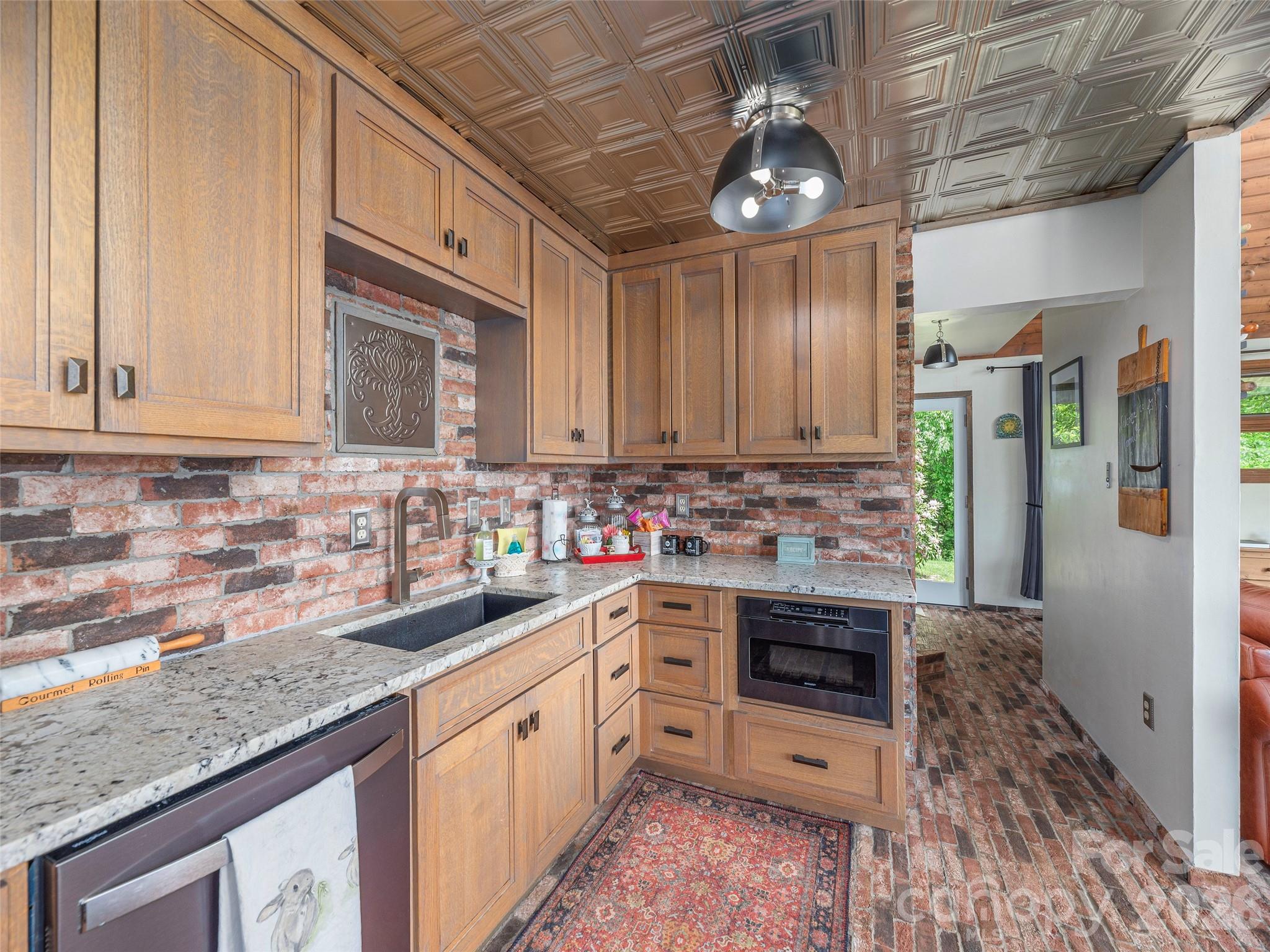 461 Ferguson Cove Loop Clyde, NC 28721 - Photo 13 of 46 a kitchen with stainless steel appliances granite countertop a sink stove and refrigerator