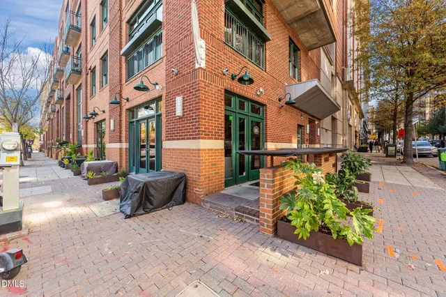 a view of a brick building next to a road